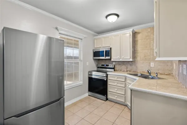 a kitchen with granite countertop a sink and a stove top oven