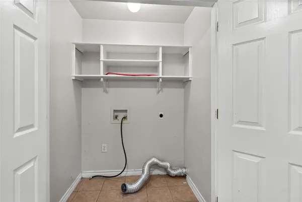 a view of a livingroom with an empty space and a window