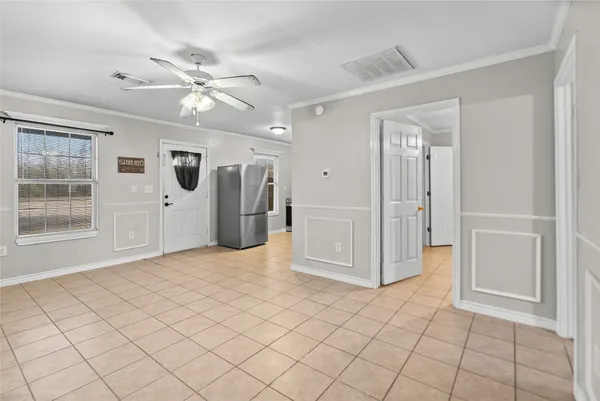 an empty room with closet and fan