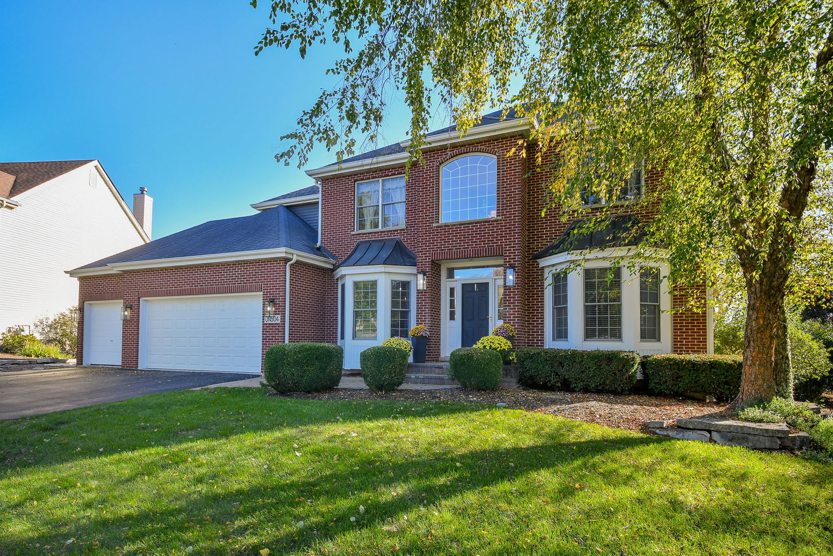 a front view of a house with a yard and porch