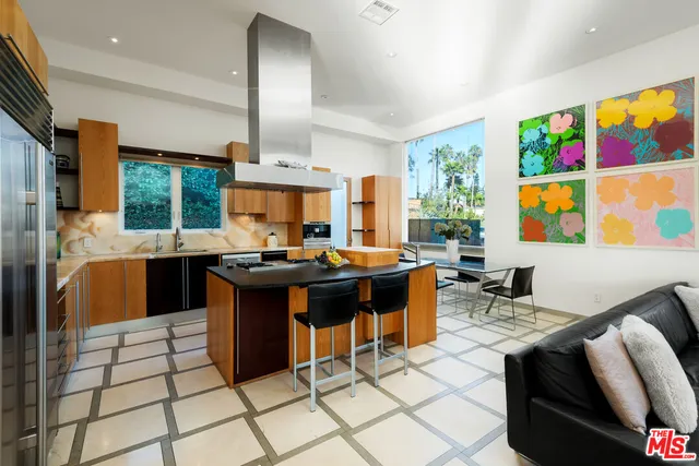 a living room with couches a flat screen computer and a large window