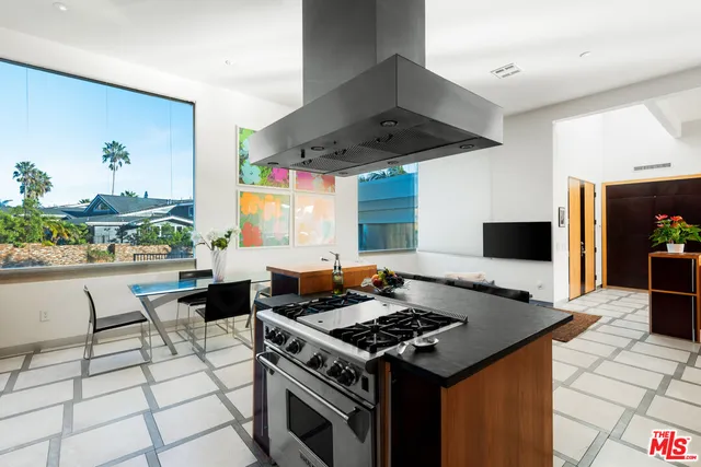 a kitchen with a stove a sink and a refrigerator