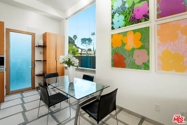 a view of a dining room with a table and chairs