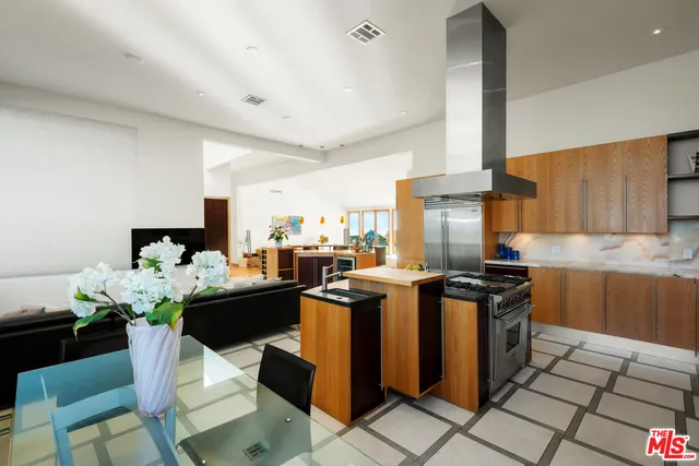 a kitchen with stainless steel appliances kitchen island granite countertop a sink and cabinets