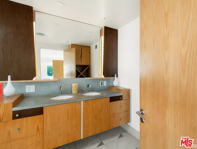 a bathroom with a granite countertop sink and a mirror