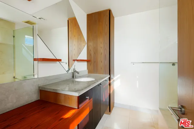 a kitchen with a sink and a mirror