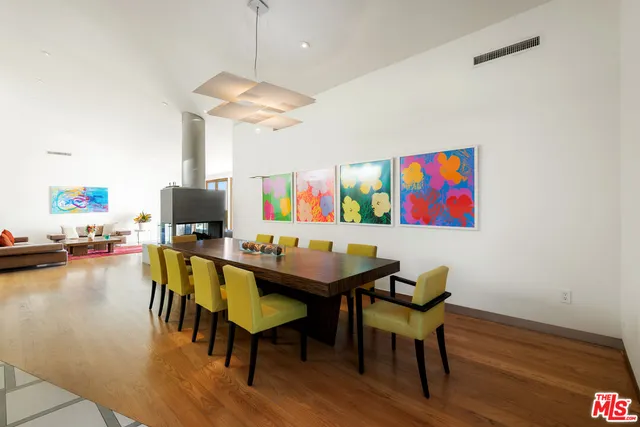 a view of a dining room with furniture a chandelier and wooden floor