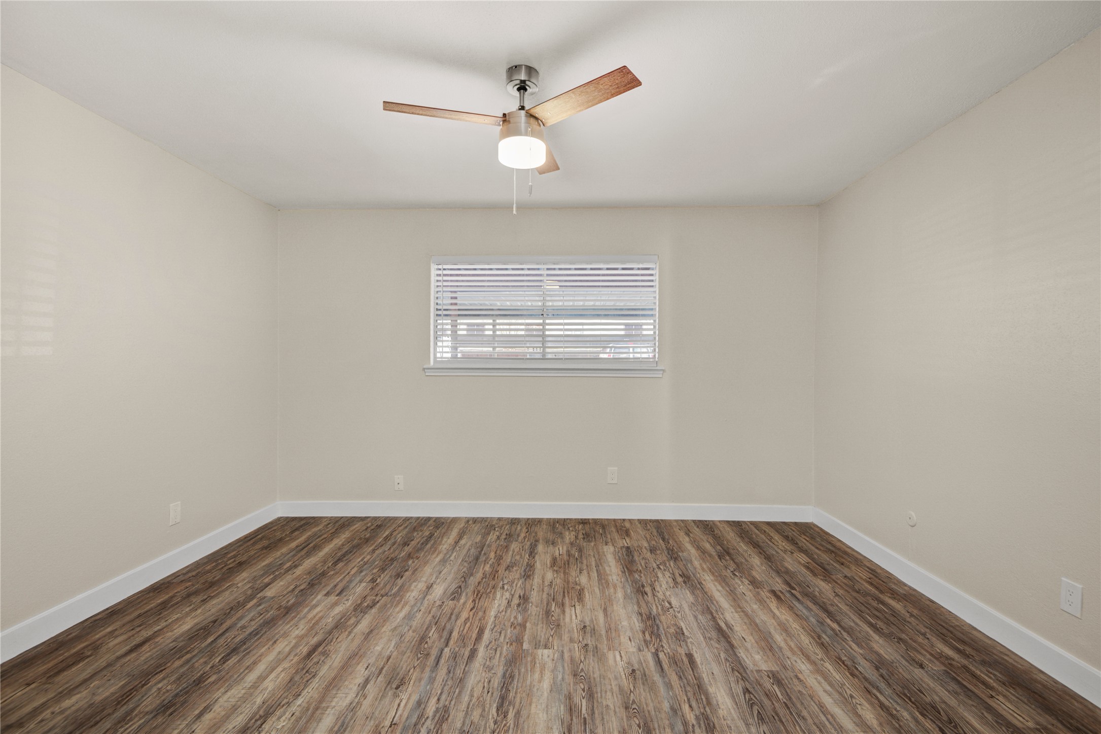 11540 Chimney Rock Road, Unit 117 Houston, TX 77035 - Photo 21 of 38 an empty room with wooden floor and windows