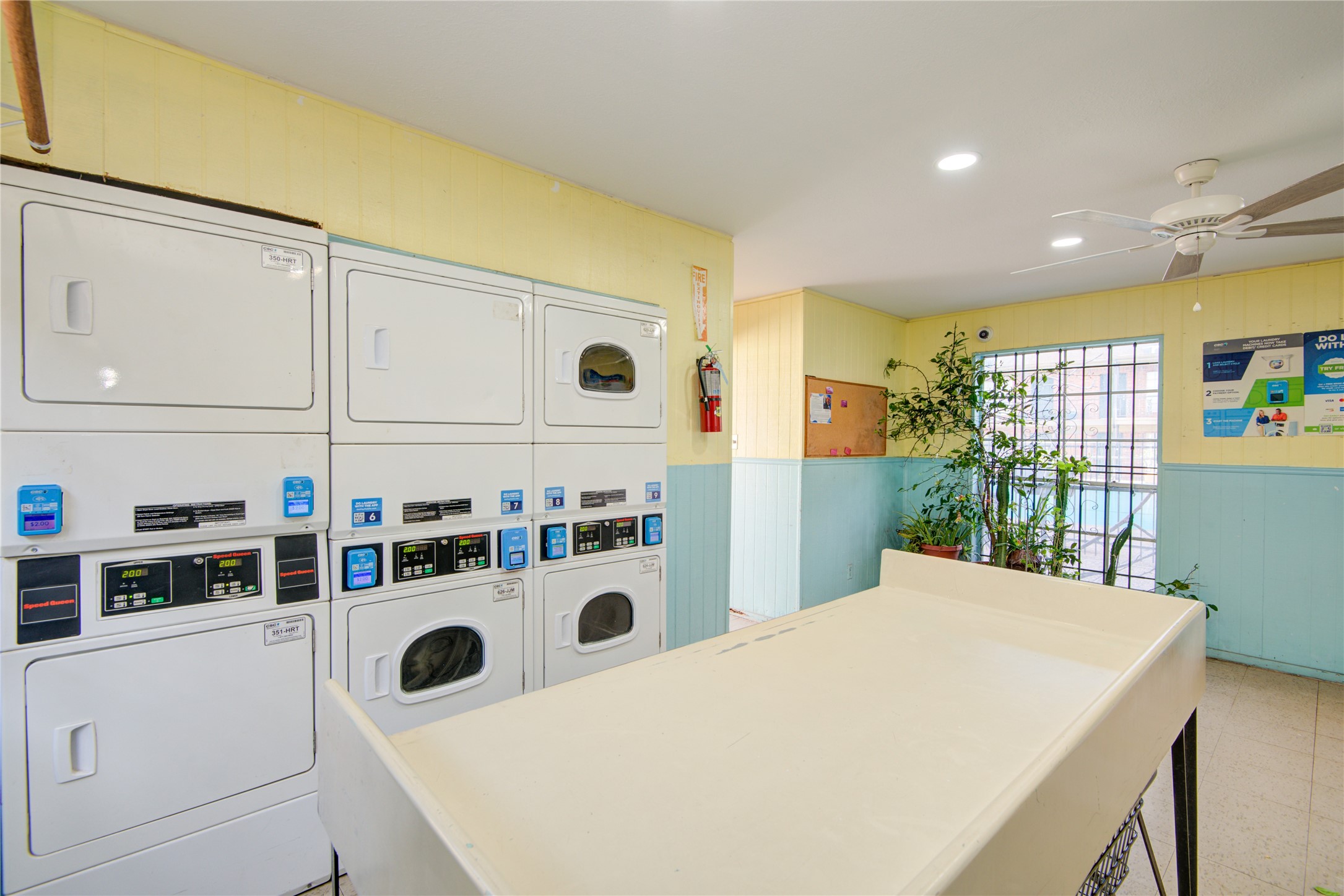 11540 Chimney Rock Road, Unit 117 Houston, TX 77035 - Photo 28 of 38 a white kitchen with a stove a refrigerator a sink dishwasher with a dining table and chairs