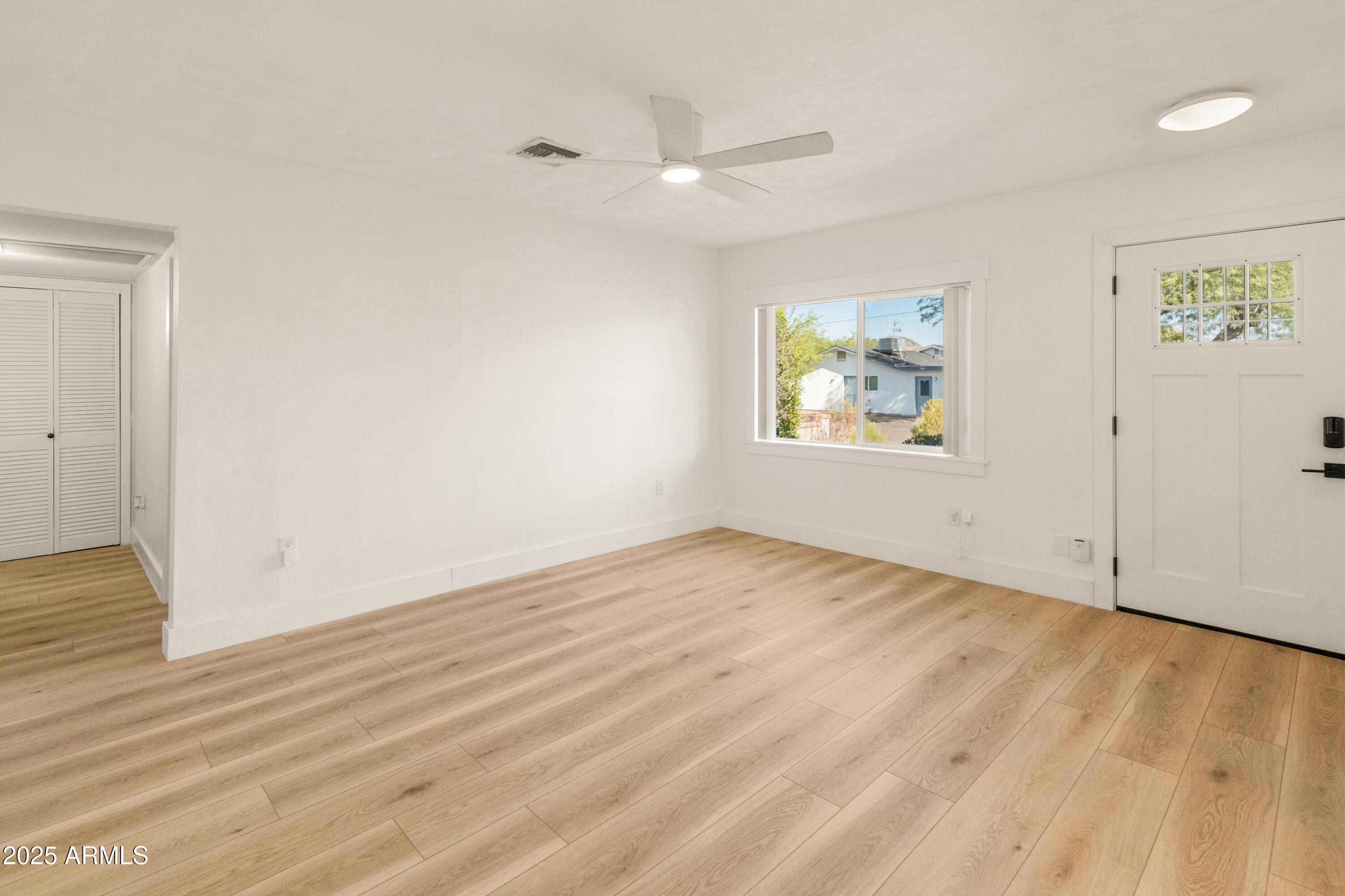 1407 East Mountain View Road Phoenix, AZ 85020 - Photo 8 of 35 an empty room with wooden floor and window