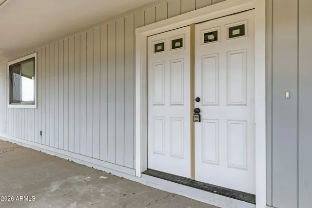 a view of a kitchen with a sink and a refrigerator