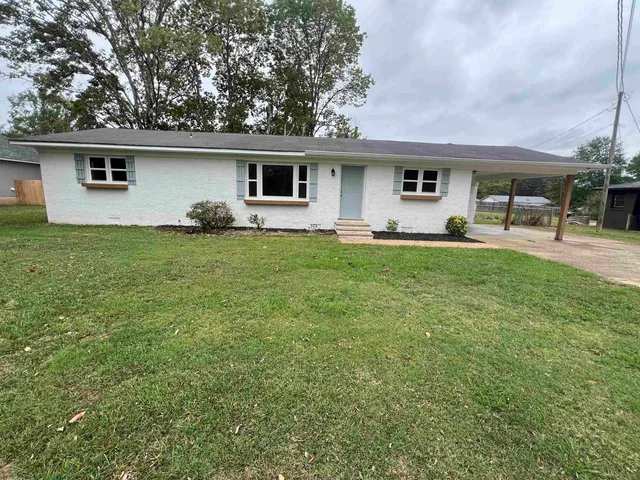 a front view of house with yard and seating area