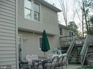 37 Saltgrass Road Ocean Pines, MD 21811 - Photo 2 of 4 a backyard of a house with seating space and trees