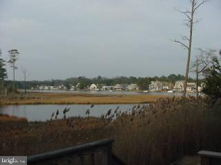 37 Saltgrass Road Ocean Pines, MD 21811 - Photo 4 of 4 a view of a lake with a city