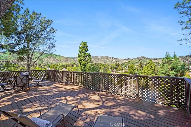 a view of a roof deck with wooden floor and fence