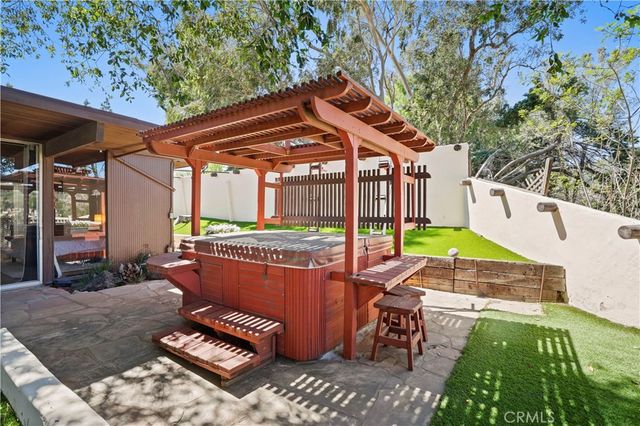 a view of a patio with table and chairs with wooden floor and fence