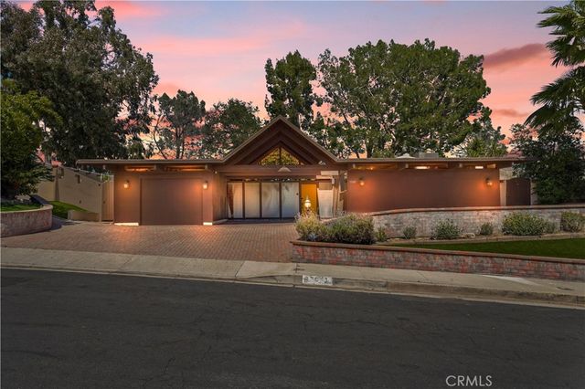 a front view of a house with a yard and a garage