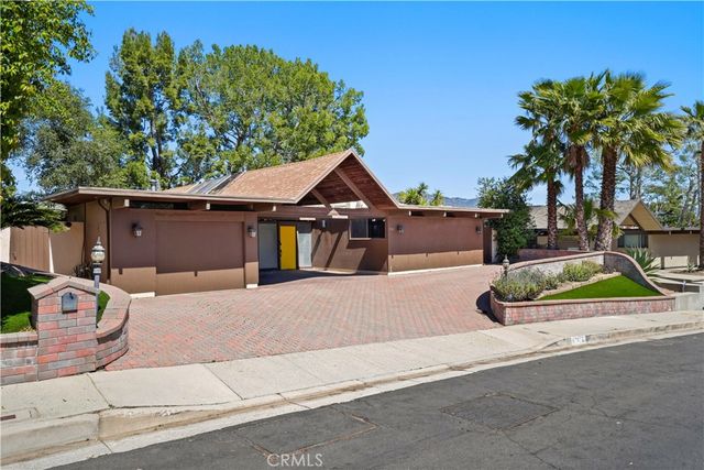 a view of house with outdoor space and trees