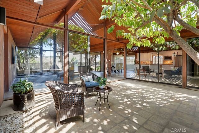 a view of a patio with a table and chairs under an umbrella