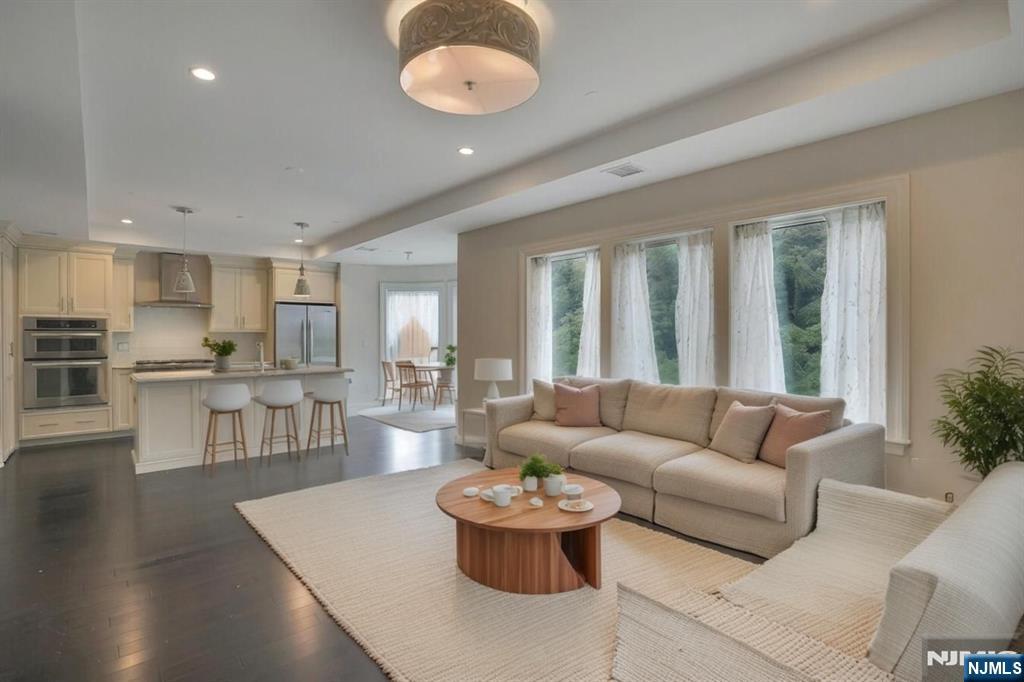 55 Eton Row Weehawken, NJ 07086 - Photo 1 of 28 a living room with furniture and a large window