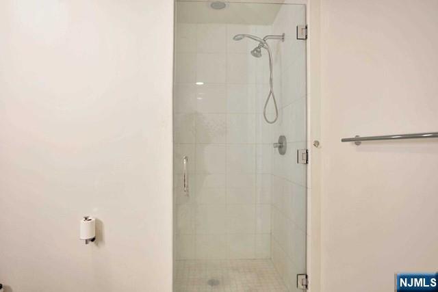 55 Eton Row Weehawken, NJ 07086 - Photo 13 of 28 a bathroom with a glass shower door