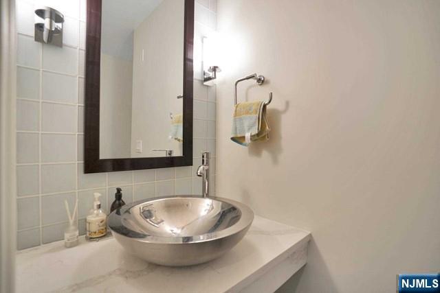 55 Eton Row Weehawken, NJ 07086 - Photo 14 of 28 a bathroom with a sink and a mirror