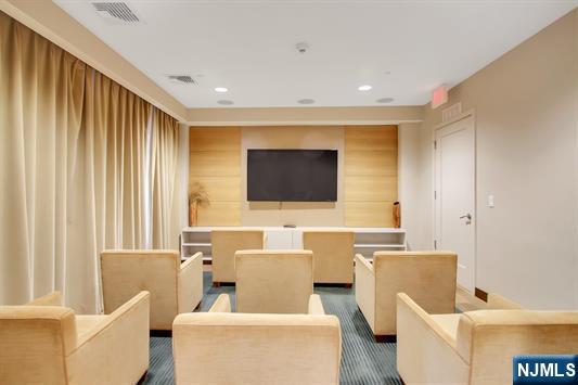 55 Eton Row Weehawken, NJ 07086 - Photo 22 of 28 a living room with furniture and a flat screen tv