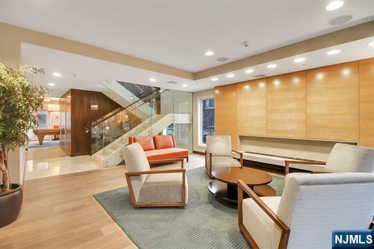 55 Eton Row Weehawken, NJ 07086 - Photo 23 of 28 a living room with furniture and a floor to ceiling window