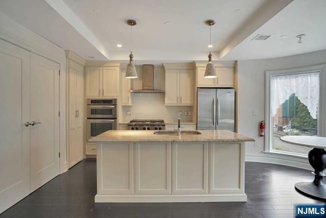 55 Eton Row Weehawken, NJ 07086 - Photo 4 of 28 a kitchen with kitchen island stainless steel appliances a sink stove and refrigerator