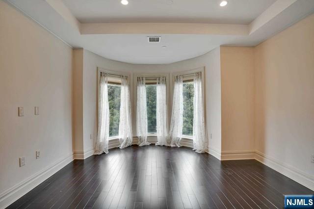 55 Eton Row Weehawken, NJ 07086 - Photo 10 of 28 an empty room with wooden floor and windows