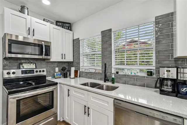 a bedroom with a bed window and a chandelier