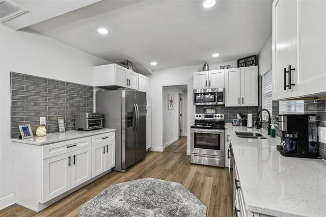 a bathroom with a tub sink and mirror