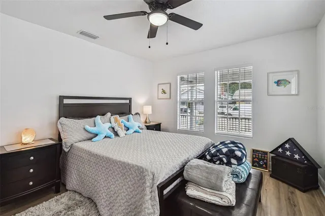 a bedroom with a bed and a chandelier