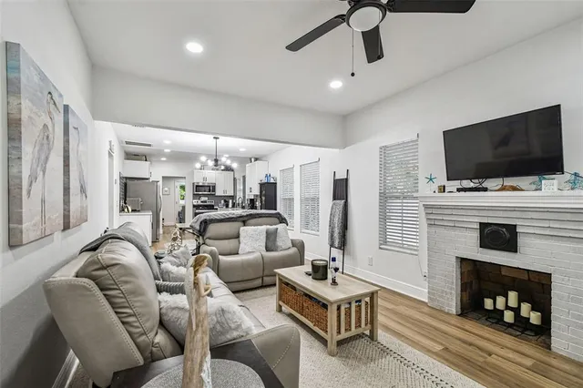 a kitchen with a refrigerator cabinets and wooden floor