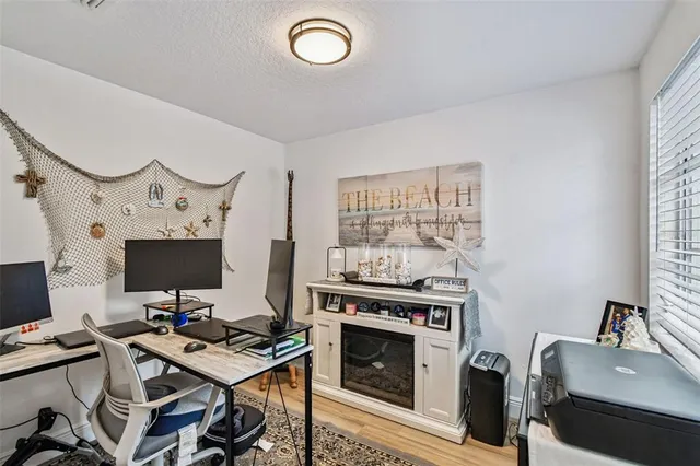 an aerial view of a house with a yard and lake view