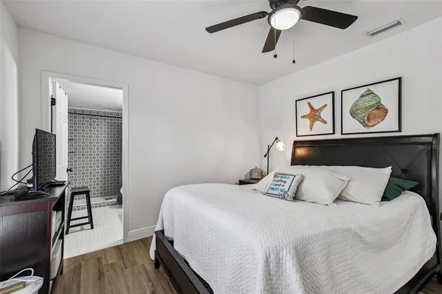a backyard of a house with table and chairs and potted plants