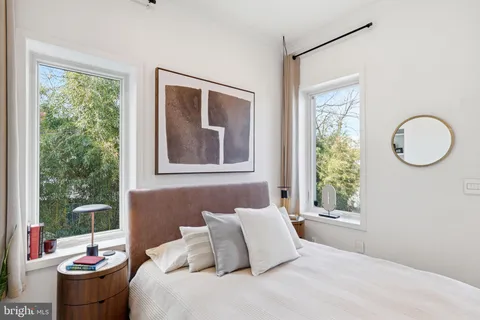 a spacious bedroom with a bed and a couch