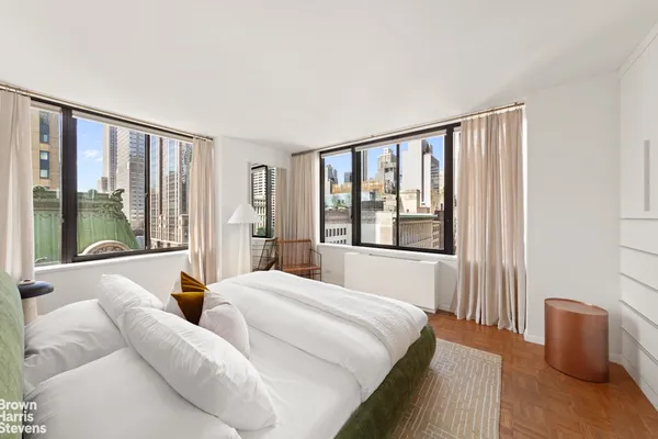 a bedroom with a large bed and a large window