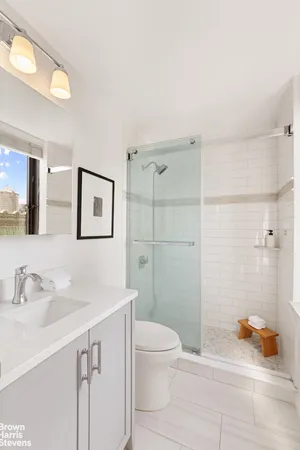 a bathroom with a sink toilet and shower