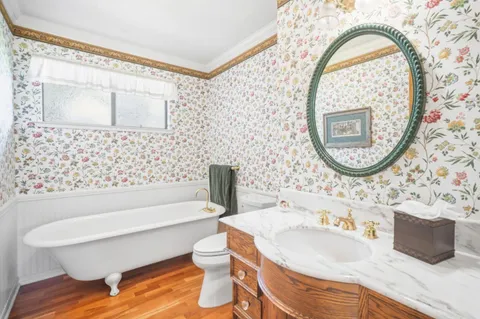 a bathroom with a sink a toilet and a mirror