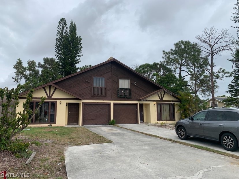 7581 Carrier Road Fort Myers, FL 33967 - Photo 1 of 14 a view of a white house and a car parked in front of it