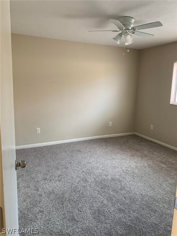 7581 Carrier Road Fort Myers, FL 33967 - Photo 10 of 14 an empty room with a ceiling fan and a window
