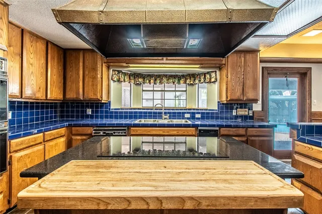 a view of a kitchen with a large window and furniture