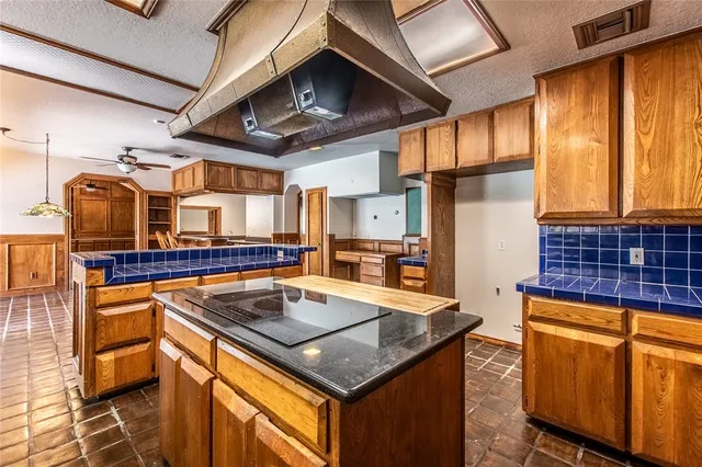 a kitchen with stainless steel appliances granite countertop sink stove top oven and cabinets