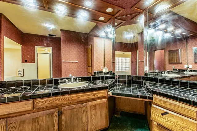 a kitchen with granite countertop a sink and a stove