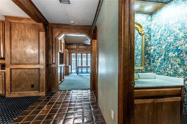 a bathroom with a glass door shower and a sink