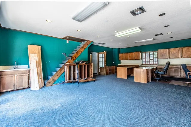 a big room with furniture and white walls