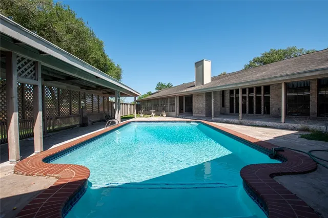 a view of swimming pool with seating space