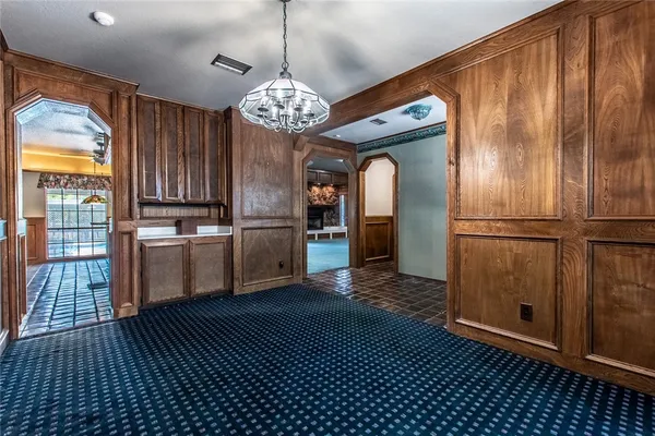 a view of a kitchen with wooden floor and a refrigerator