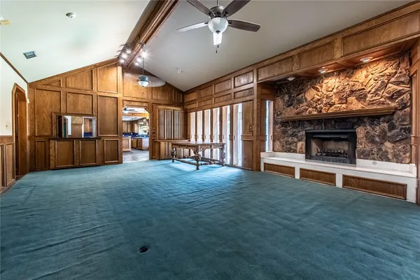 a view of an empty room with a fireplace and a window
